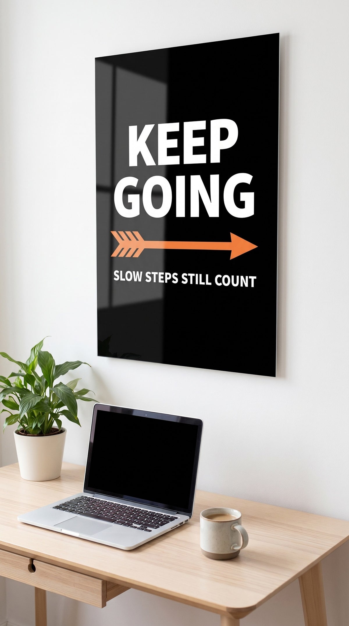 Keep Going acrylic sign in a workspace