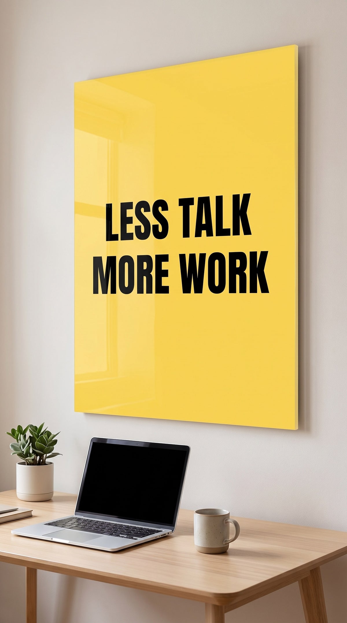 Less Talk More Work acrylic sign in a workspace
