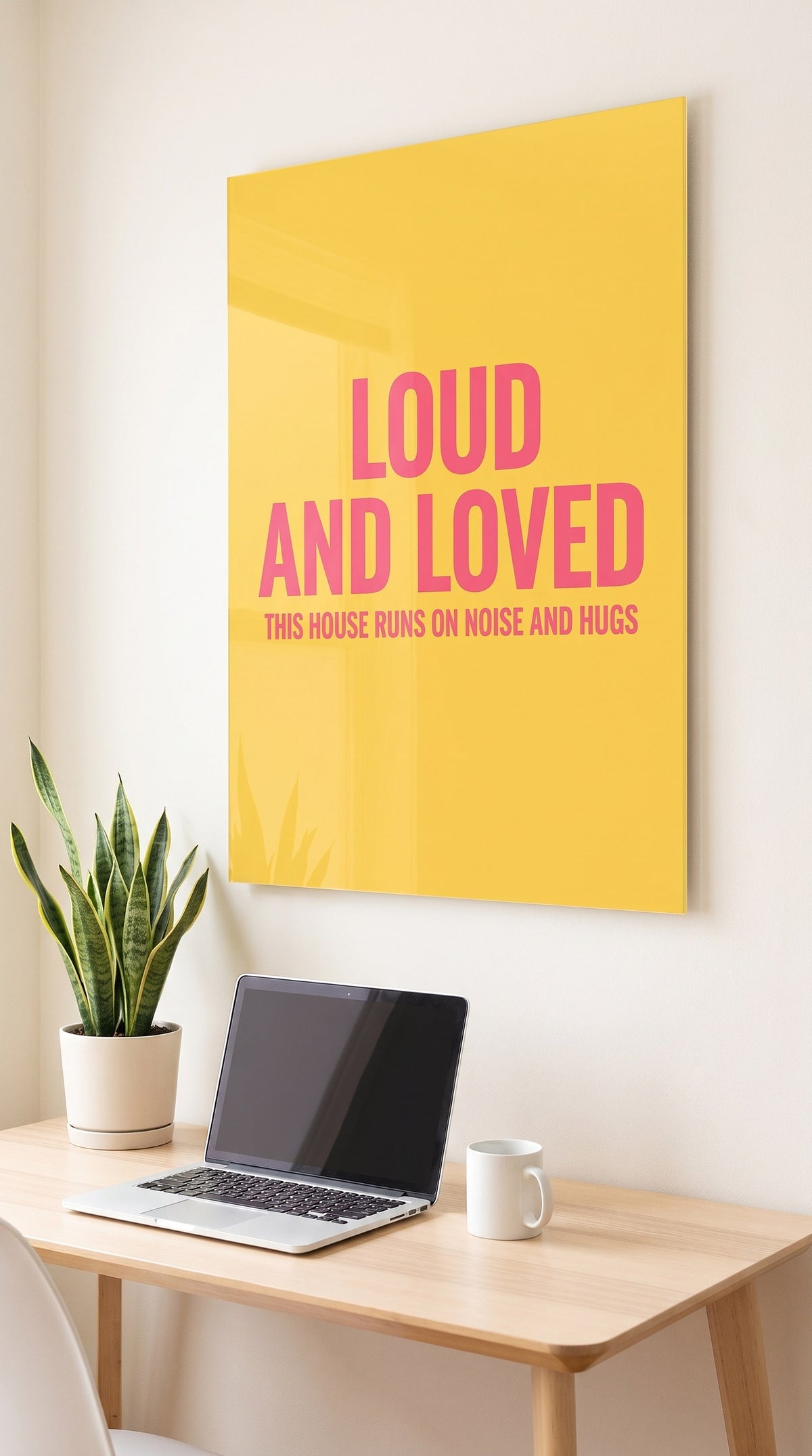 Loud And Loved acrylic sign in a workspace
