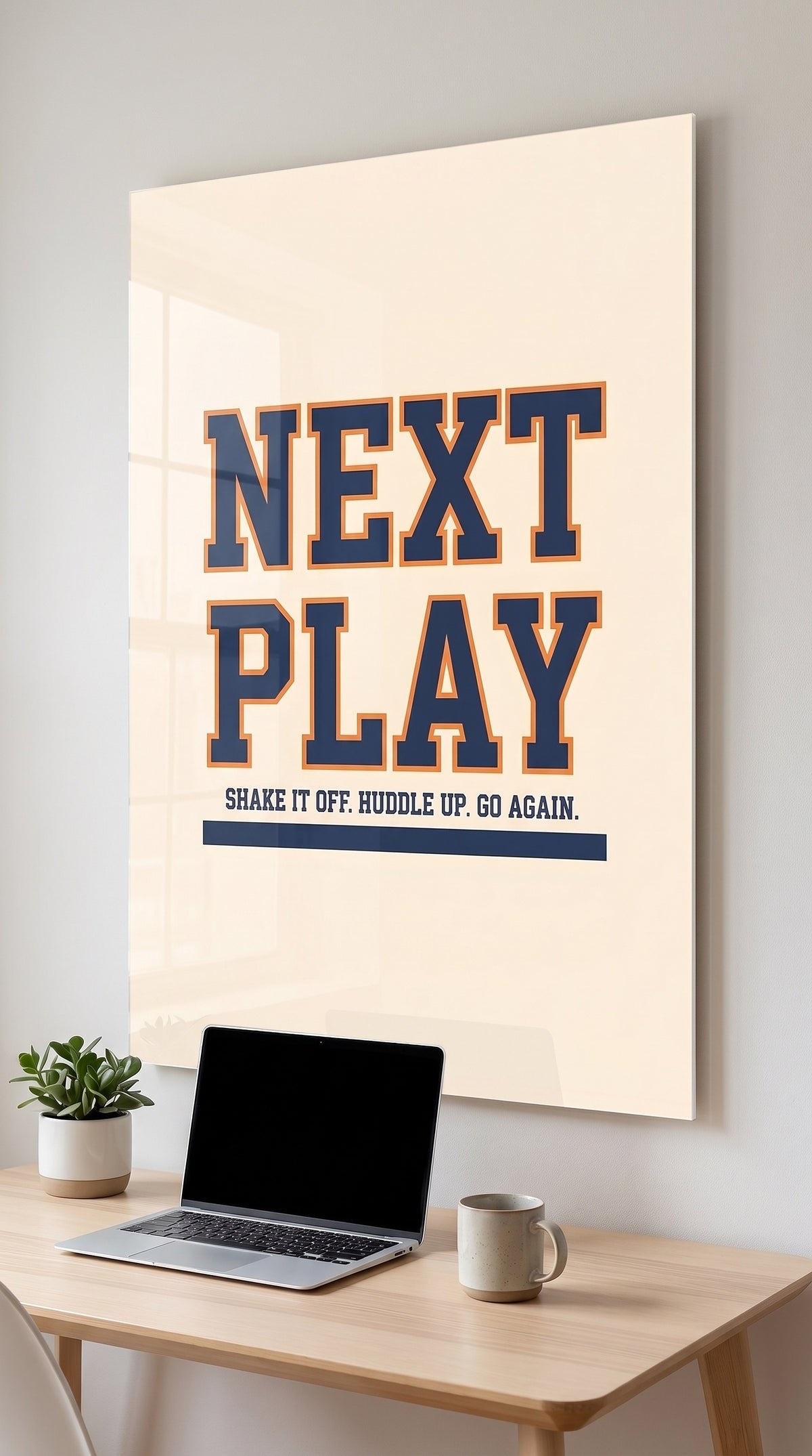 Next Play acrylic sign in a workspace