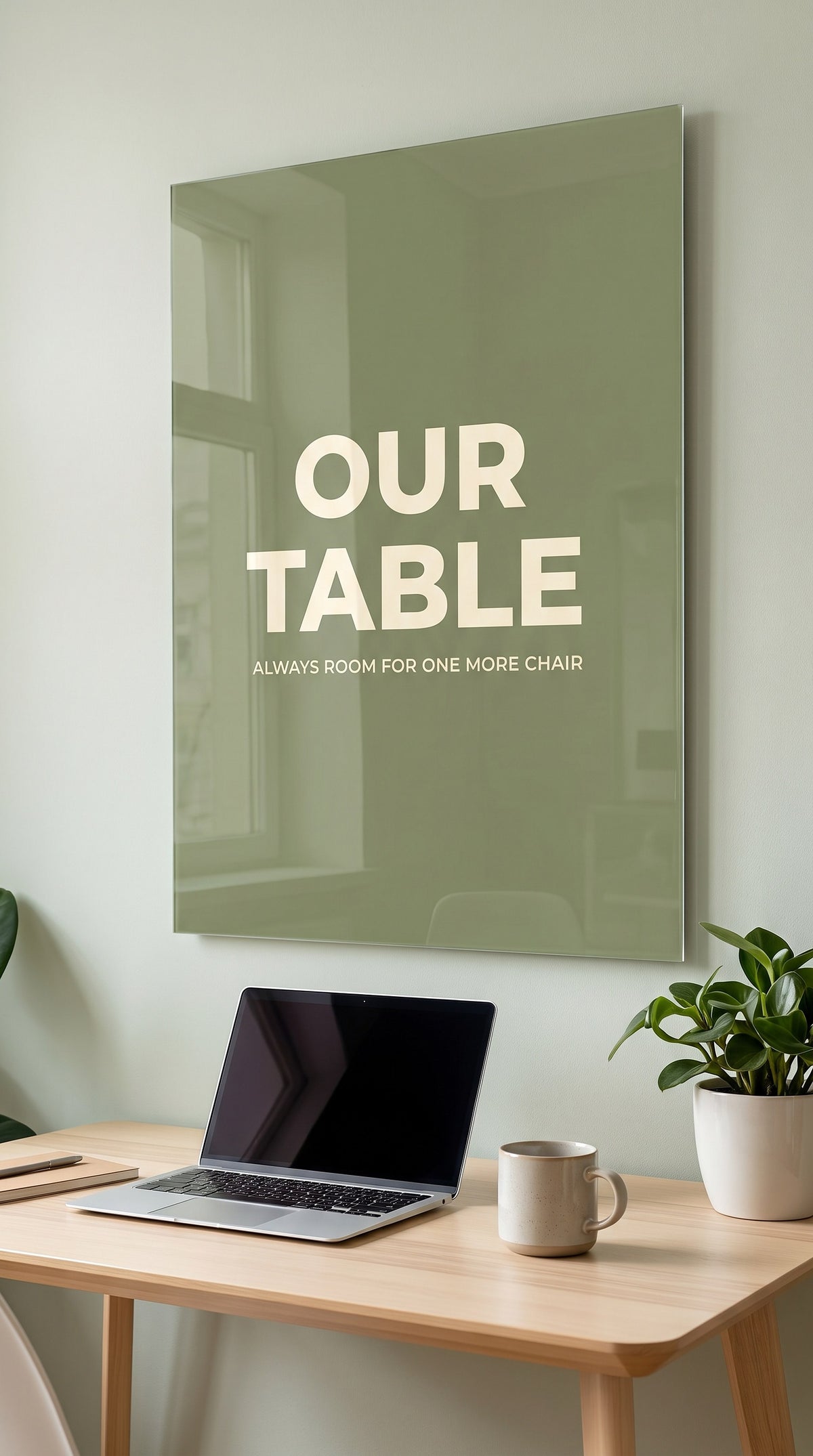 Our Table acrylic sign in a workspace