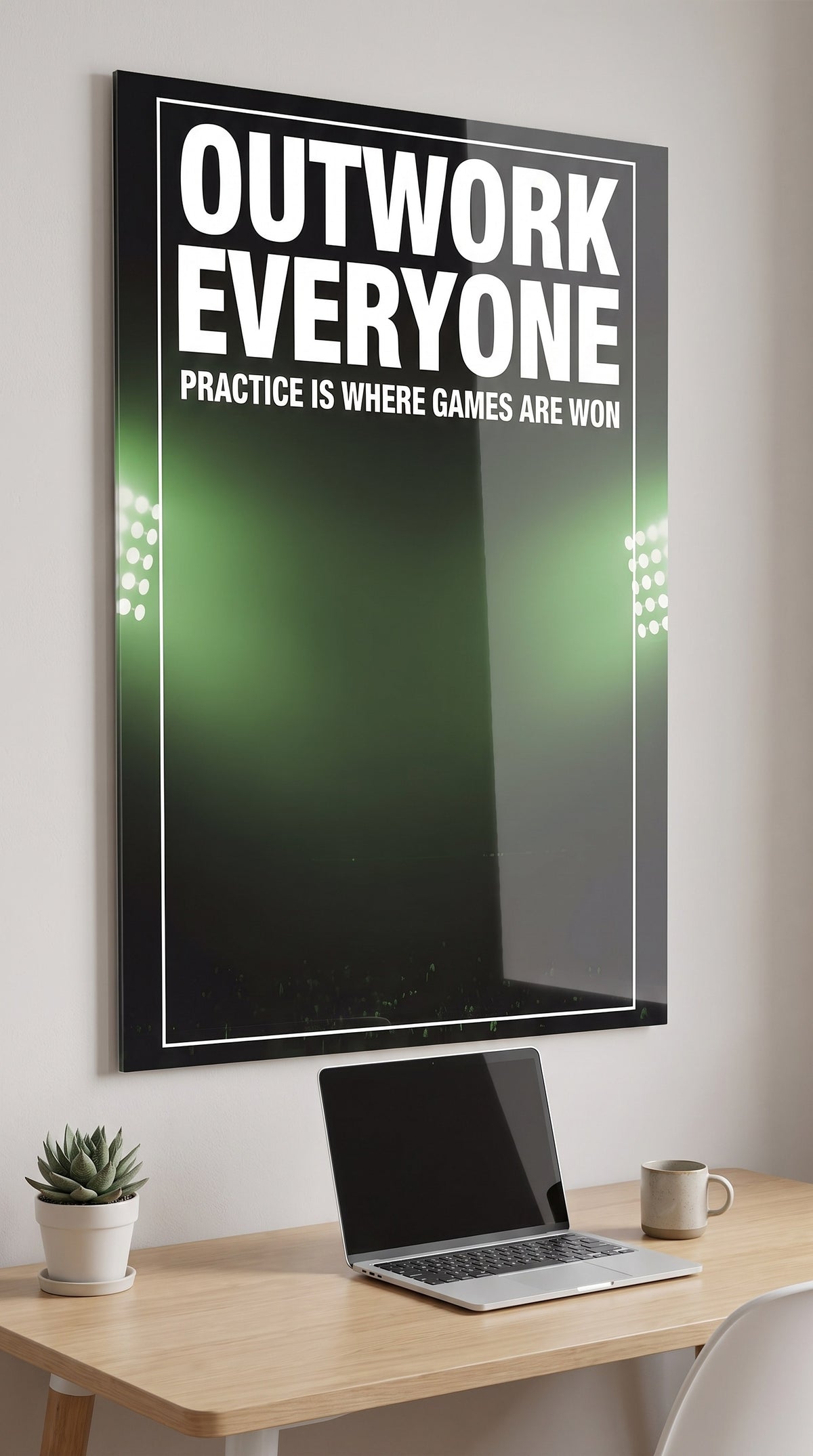 Outwork Everyone acrylic sign in a workspace