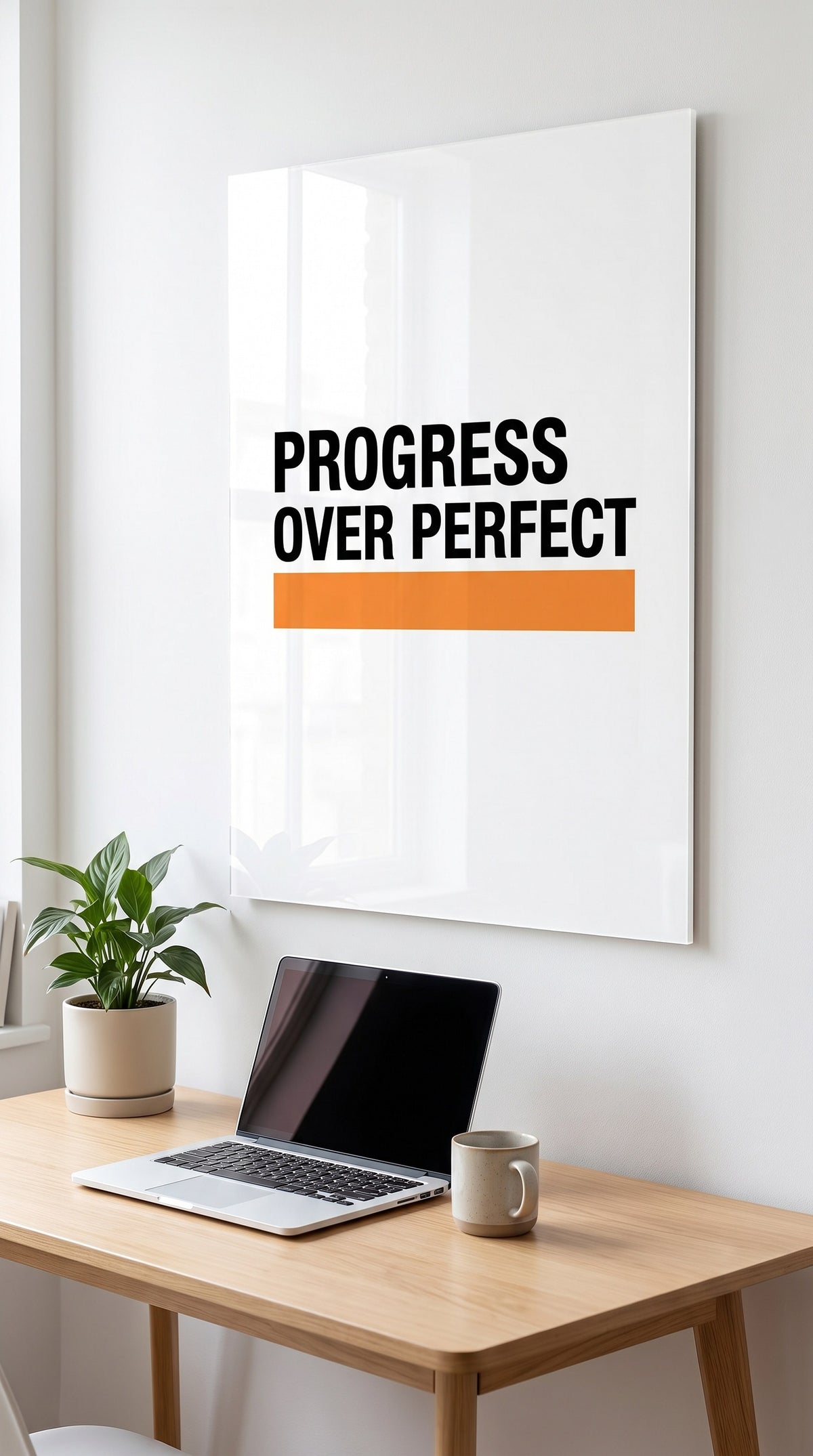 Progress Over Perfect acrylic sign in a workspace