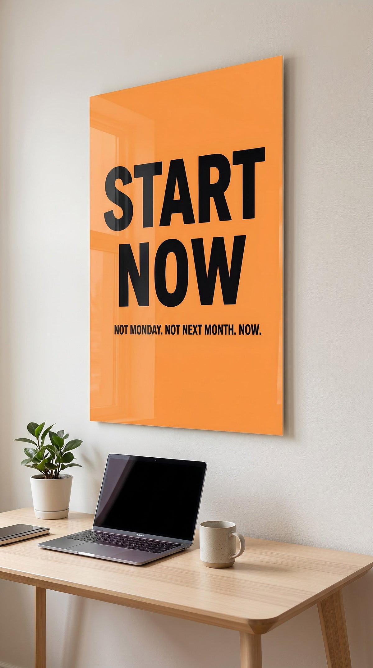Start Now acrylic sign in a workspace