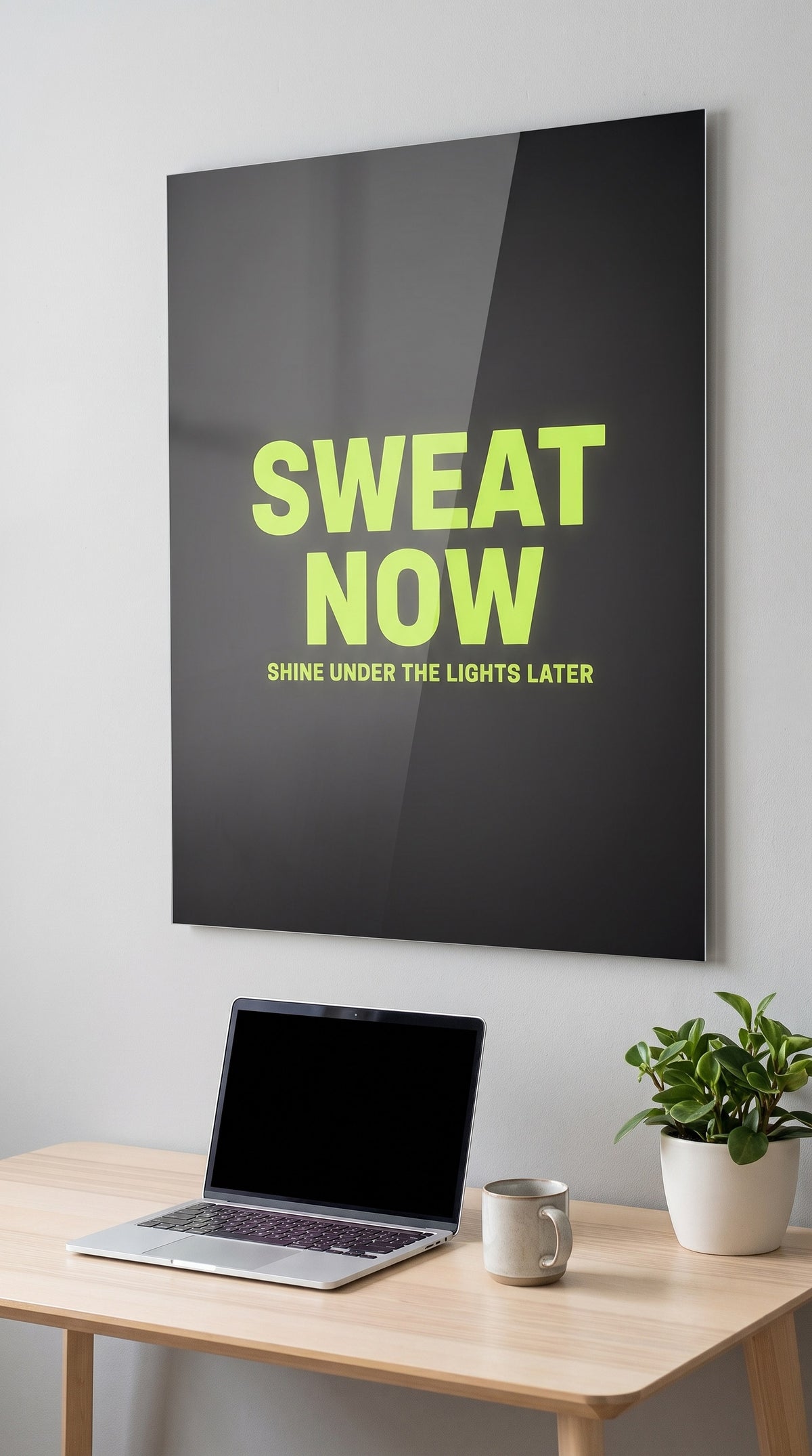 Sweat Now acrylic sign in a workspace